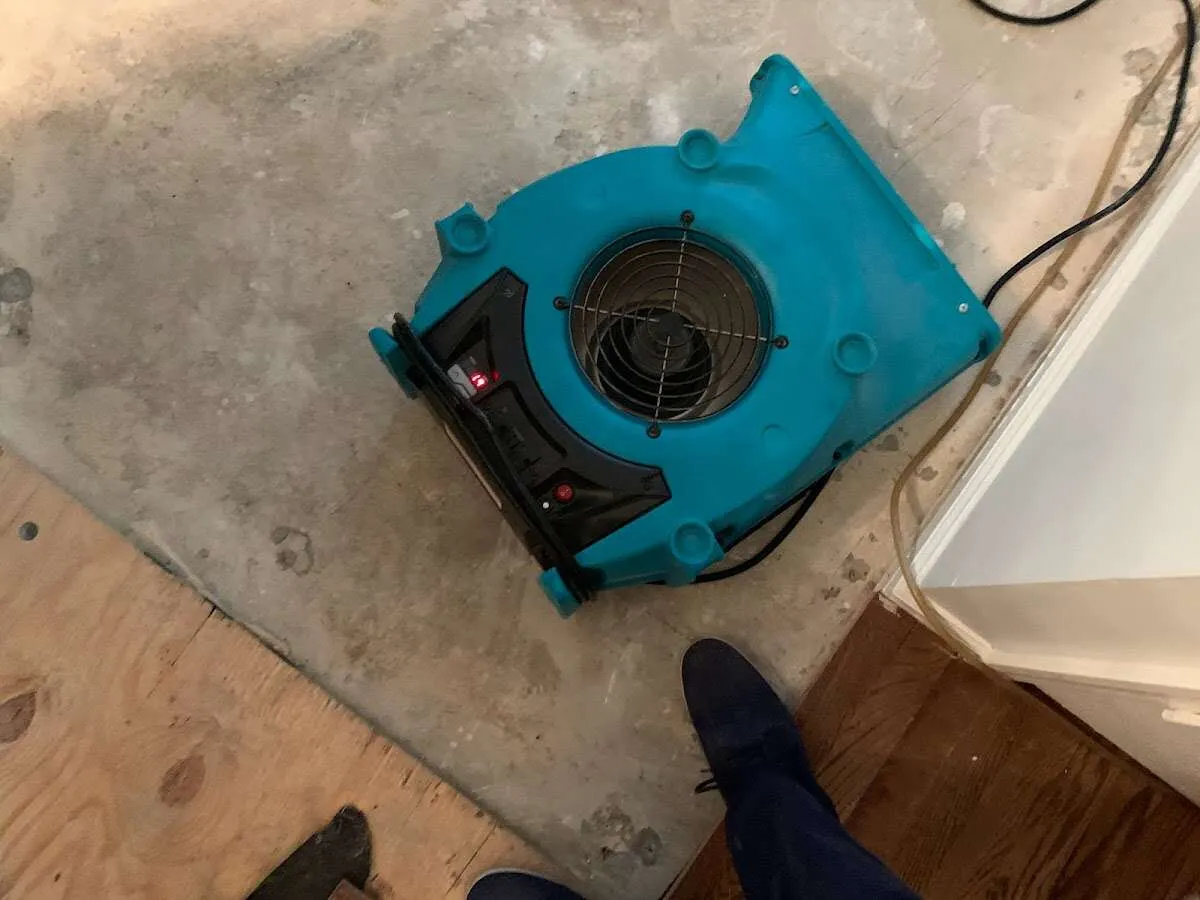 Air mover drying subfloor during Commercial Water Damage Restoration in Woodridge